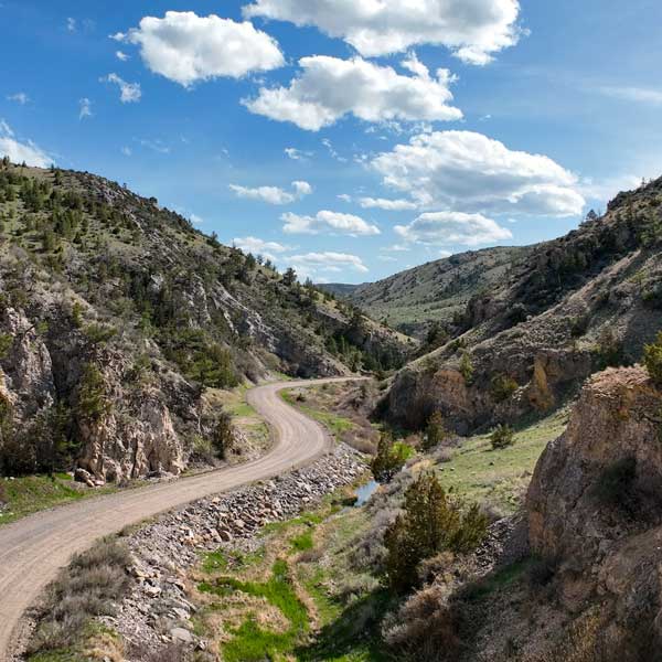 Milligan-Canyon-4 Beautiful scenic view of a road curving through Milligan Canyon in Montana