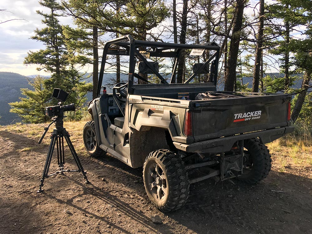Behind-the-scenes_Credit-Mike-Dreesman-Tempest-Technologies_16 UTV parked in forest next to camera set up on a tripod